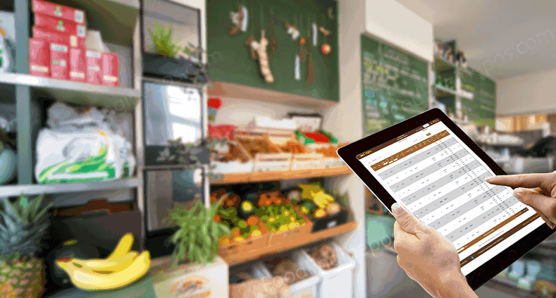 A pair of hands scrolling through FoodEngine Inventory Software inside a stock room